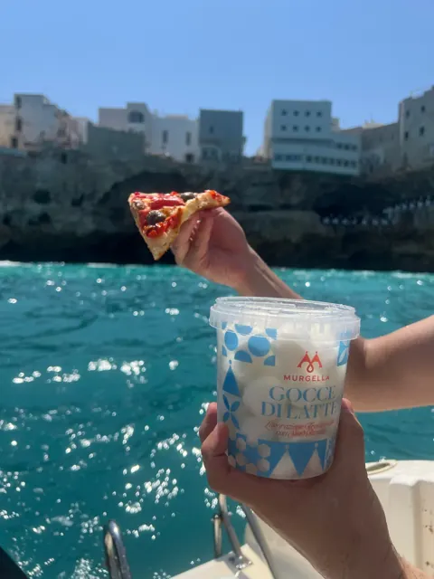 Pizza slice on a boat in Polignano a Mare