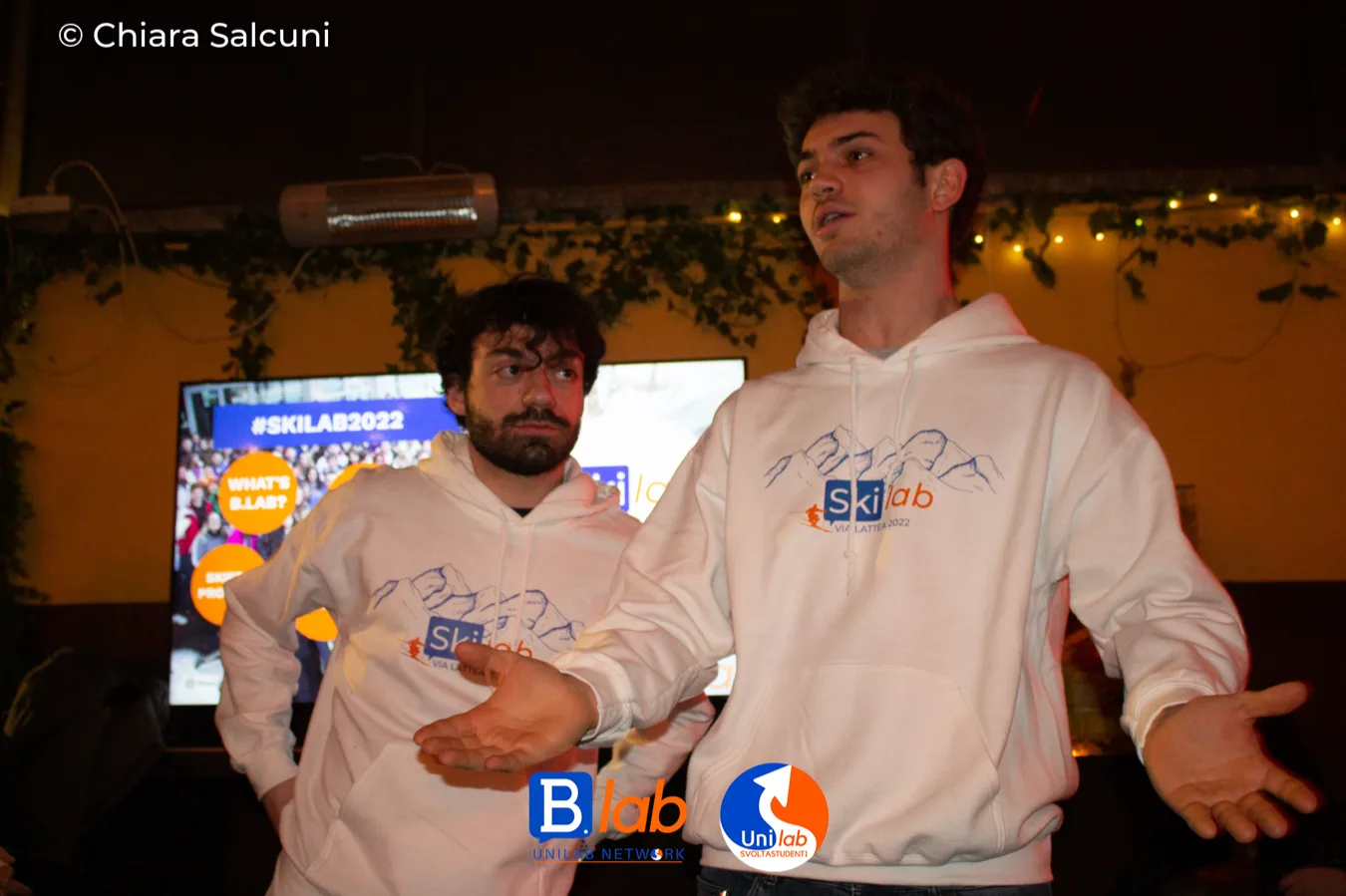 Two B.lab organisers in matching hoodies at a party