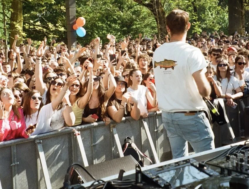 Saverio on a stage in front of a large crowd at a student event