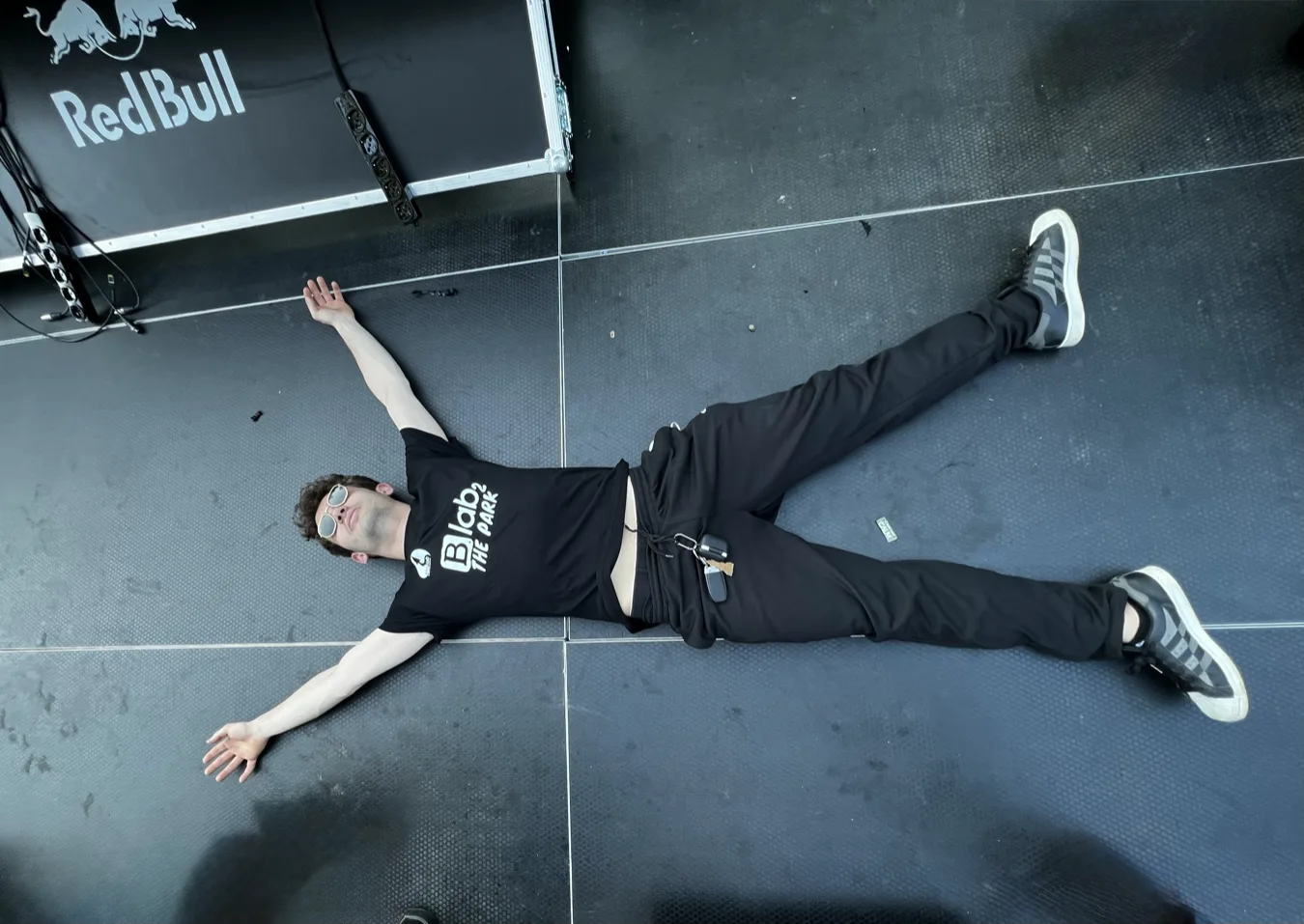 Saverio lying on the floor of a Red Bull event, arms spread