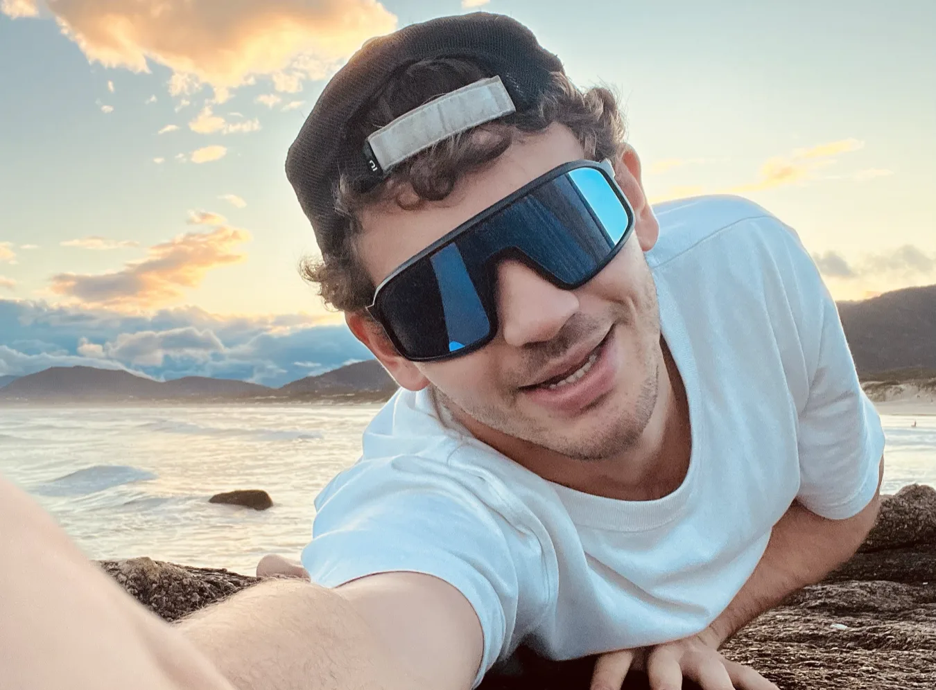 Selfie with sunglasses on a rock by the sea
